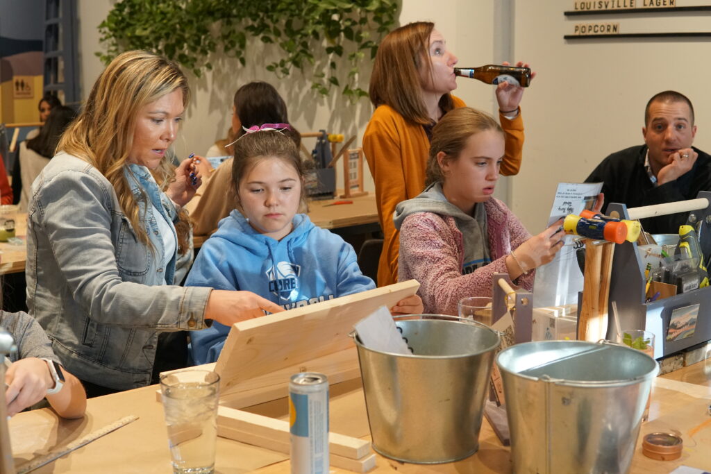 A mother and daughter work on a craft